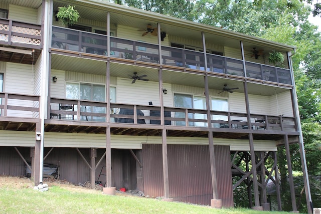 rear view of property with ceiling fan and a balcony