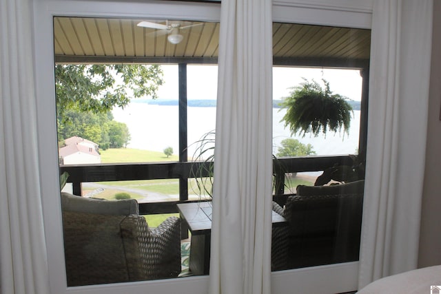 room details featuring a water view and ceiling fan