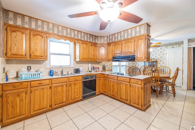 kitchen featuring light tile patterned flooring, black appliances, sink, ceiling fan, and kitchen peninsula