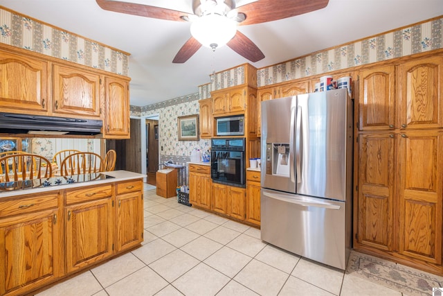 kitchen with light tile patterned floors, black appliances, and ceiling fan