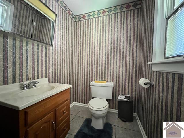 bathroom with tile patterned flooring, toilet, and vanity