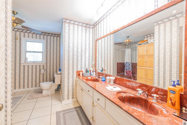 bathroom with toilet, tile patterned floors, and double sink vanity