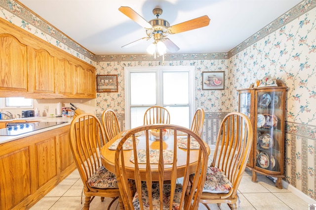 tiled dining area featuring ceiling fan