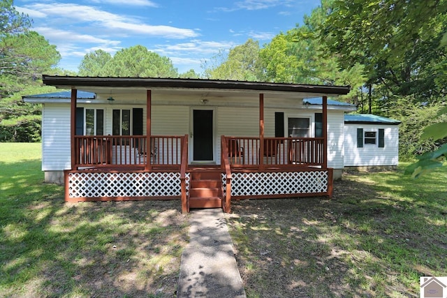 rear view of house with a porch and a lawn