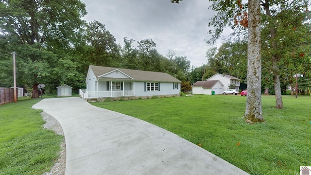 ranch-style home featuring a garage, an outbuilding, and a front yard