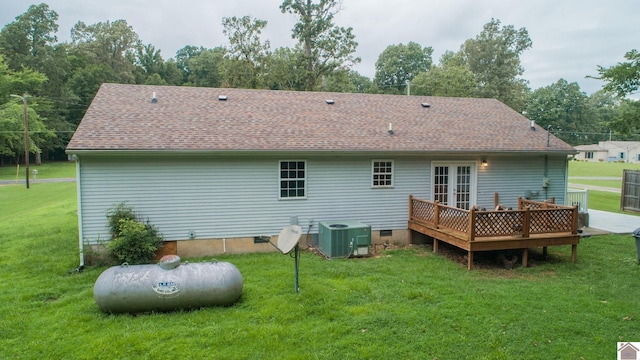 back of property featuring french doors, a deck, a lawn, and cooling unit