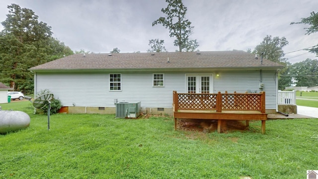 rear view of house featuring a deck, central AC, and a yard