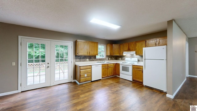 kitchen featuring french doors, sink, a textured ceiling, dark hardwood / wood-style floors, and white appliances