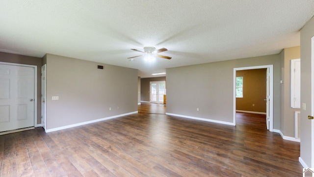 unfurnished room featuring ceiling fan, dark wood-type flooring, and a textured ceiling