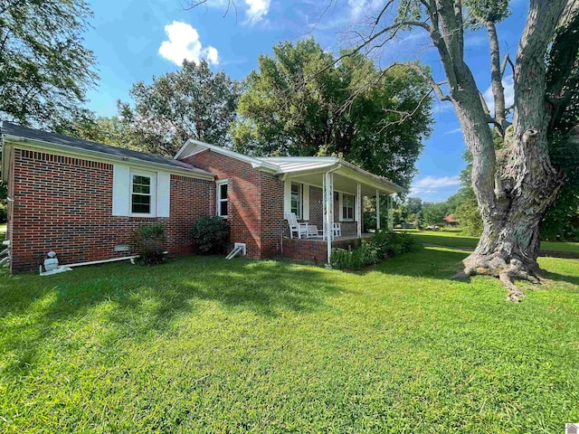 view of front of house with a front yard and covered porch