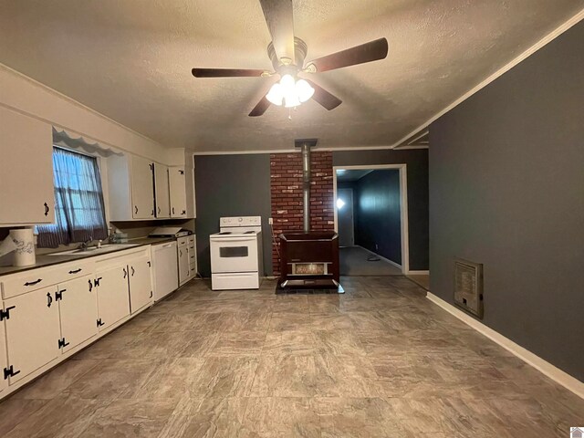 kitchen with white cabinetry, a wood stove, white appliances, tile patterned floors, and brick wall