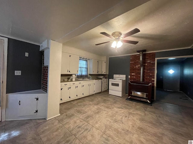 kitchen with tile patterned flooring, a wood stove, white appliances, white cabinets, and ceiling fan