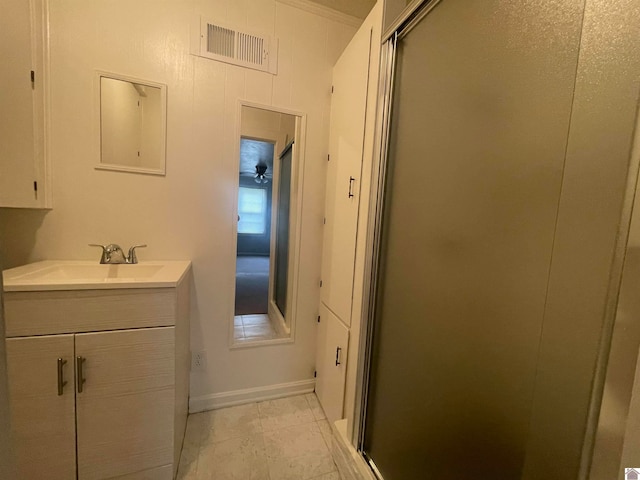 bathroom with tile patterned floors, vanity, and an enclosed shower