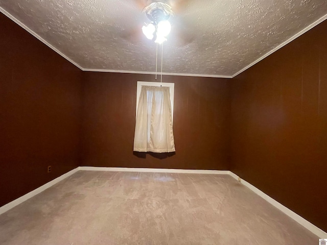 carpeted empty room featuring crown molding, a textured ceiling, and ceiling fan