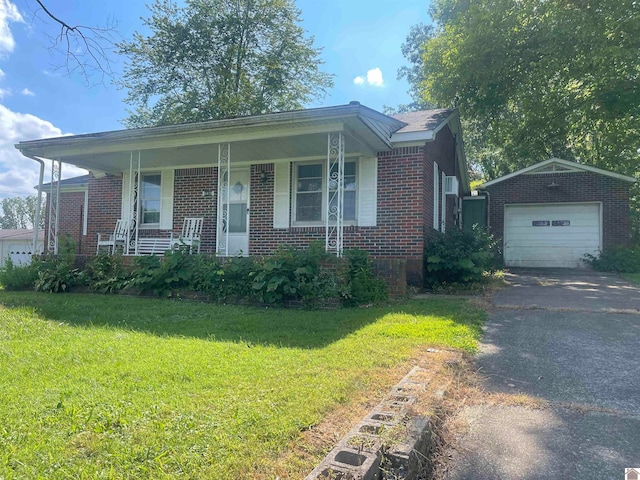 view of front of property featuring an outbuilding, a porch, a garage, and a front lawn