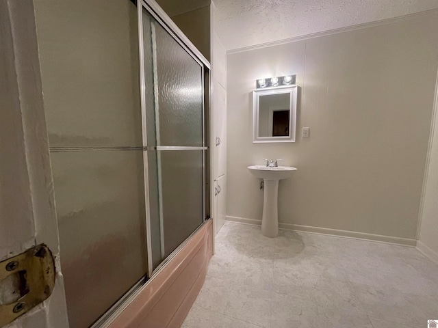 bathroom with combined bath / shower with glass door, tile patterned floors, crown molding, and a textured ceiling