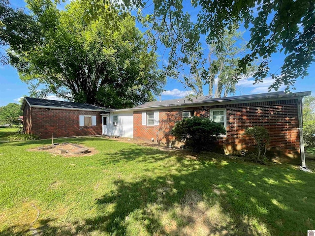 rear view of property with a yard