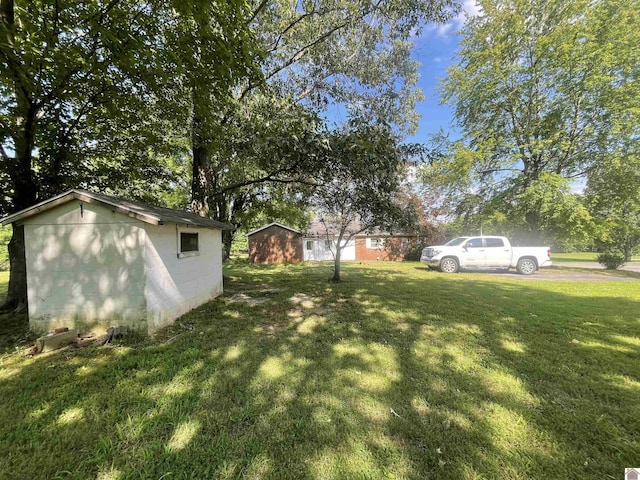 view of yard with a storage shed and an outbuilding