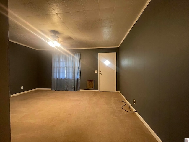 spare room with ornamental molding, carpet flooring, and ceiling fan