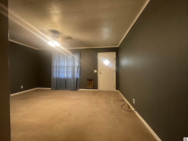 entrance foyer featuring carpet floors, crown molding, and baseboards