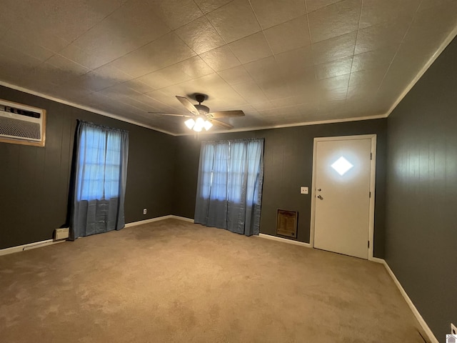 entrance foyer with carpet, a wall unit AC, a ceiling fan, and crown molding