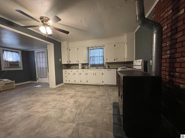 kitchen featuring baseboards, white cabinets, a ceiling fan, a wood stove, and white dishwasher