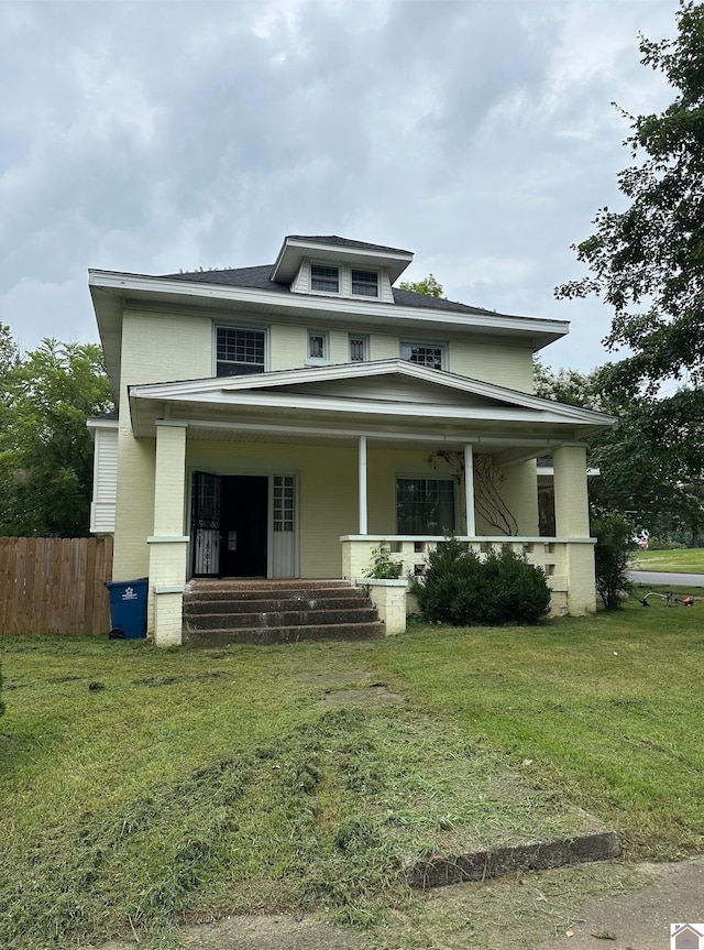 view of front facade with a front lawn and a porch