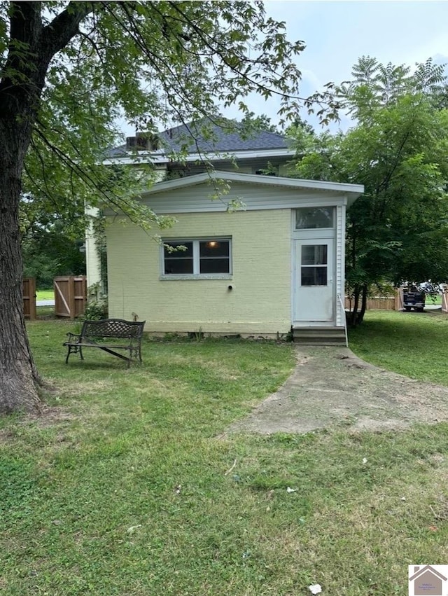 back of property with a lawn