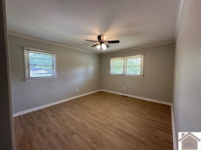 empty room with ceiling fan, ornamental molding, and dark hardwood / wood-style floors