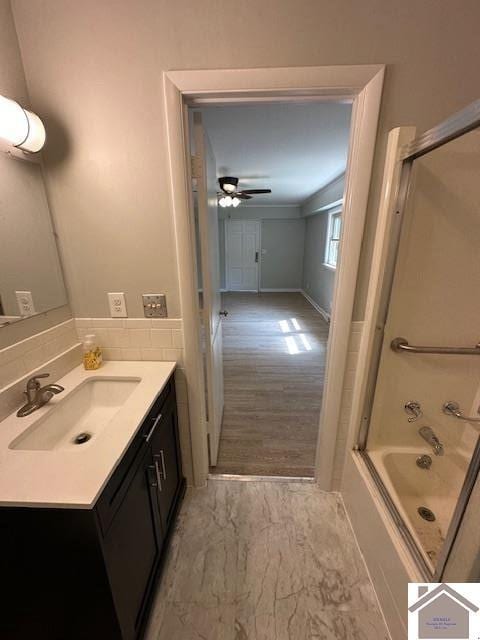 bathroom featuring ceiling fan, vanity, and shower / bathing tub combination