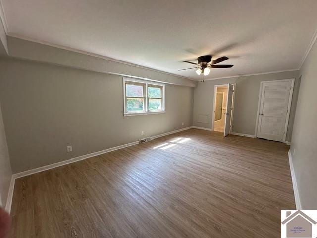 unfurnished bedroom with hardwood / wood-style floors, crown molding, and ceiling fan