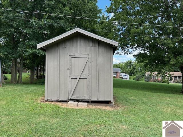 view of outbuilding featuring a lawn