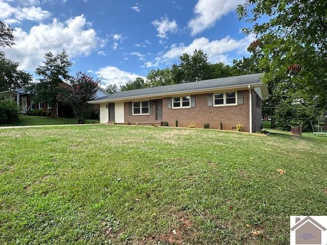 rear view of property with a lawn