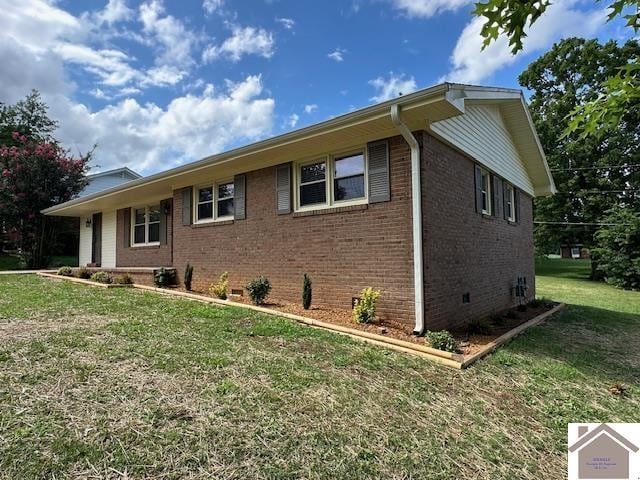 view of side of home with a lawn