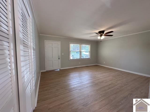 unfurnished room with ceiling fan, ornamental molding, and dark hardwood / wood-style flooring