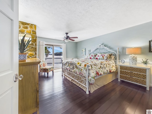 bedroom featuring ceiling fan, access to outside, hardwood / wood-style floors, and a textured ceiling