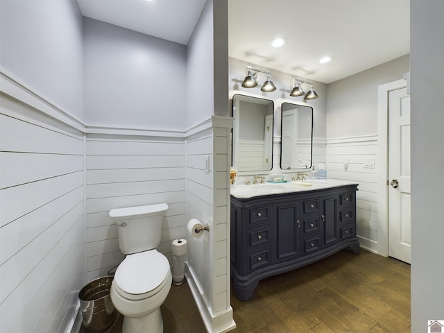 bathroom featuring vanity, toilet, and hardwood / wood-style floors