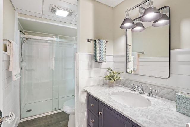 bathroom featuring vanity, an enclosed shower, hardwood / wood-style flooring, and toilet