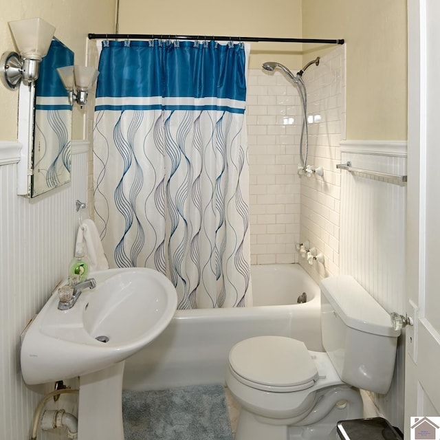 bathroom featuring shower / bathtub combination with curtain and toilet