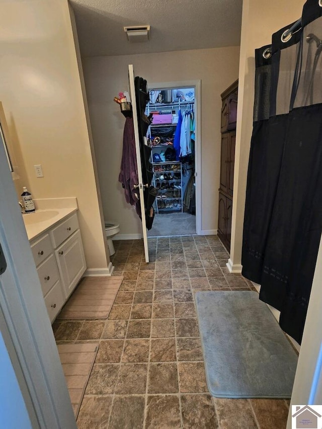 bathroom with vanity, tile patterned flooring, and toilet