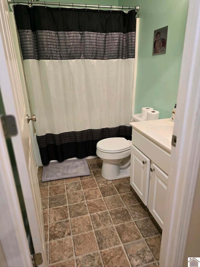 bathroom with tile patterned floors, toilet, and vanity