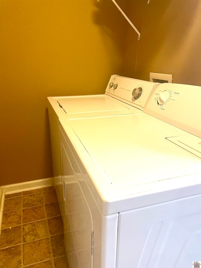 washroom with tile patterned floors and washer and clothes dryer