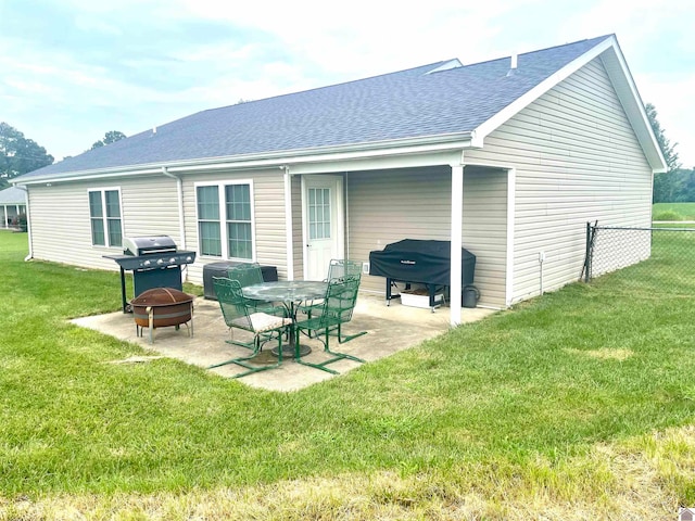 rear view of house featuring a patio and a lawn