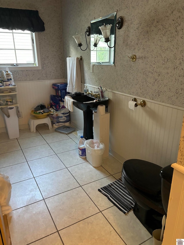 bathroom with toilet and tile patterned flooring