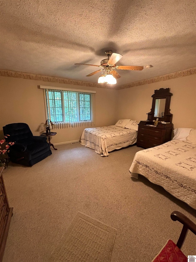 carpeted bedroom with a textured ceiling and ceiling fan