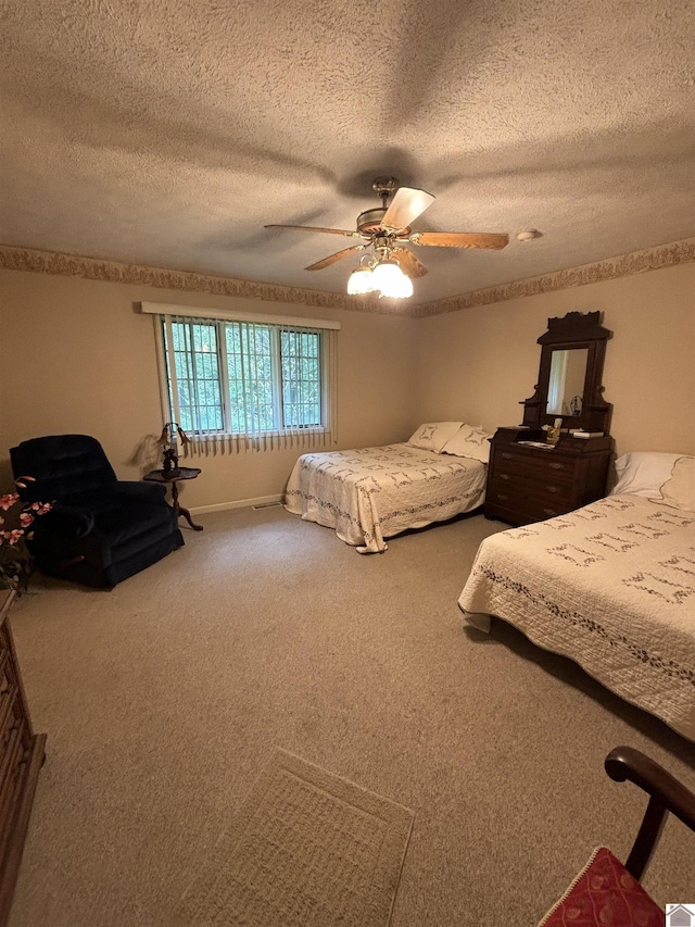 carpeted bedroom with ceiling fan and a textured ceiling