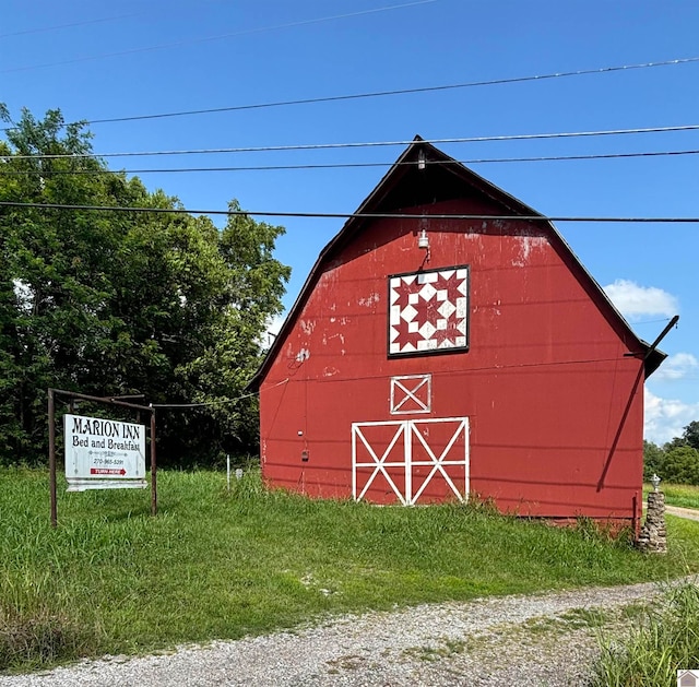 view of outbuilding with a lawn