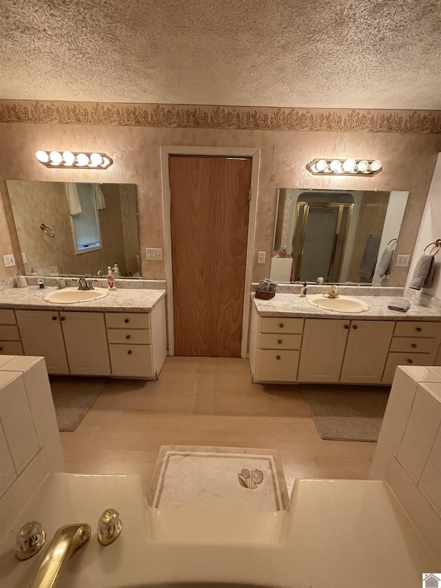 bathroom with vanity and a textured ceiling