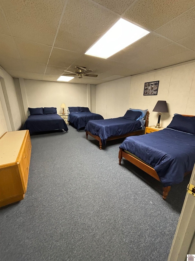 bedroom featuring a paneled ceiling, ceiling fan, and carpet flooring