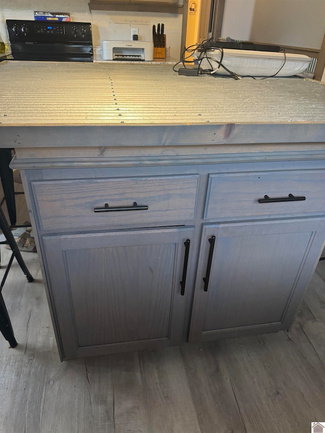 room details with range and dark wood-type flooring